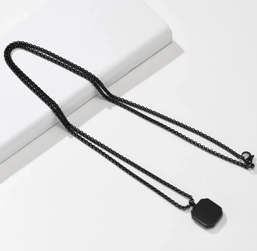 Black geometric pendant necklace product close-up