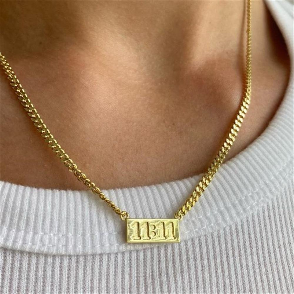 11:11 gold-tone rectangular pendant necklace worn