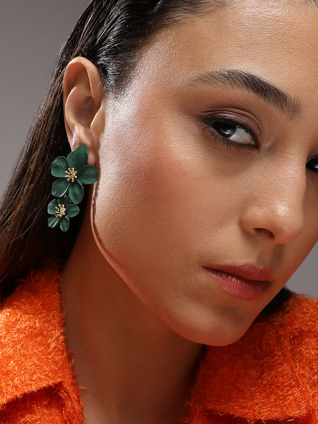 Teal floral dangle earrings worn with traditional attire