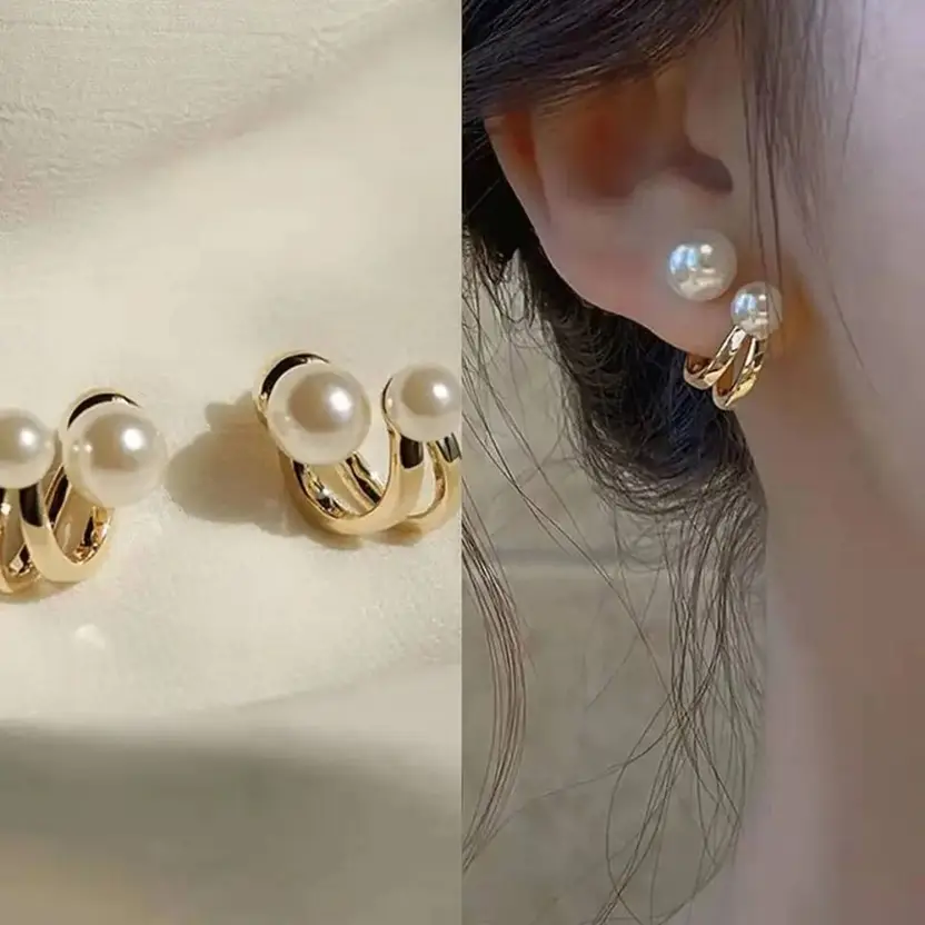 Gold-tone pearl double hoop earrings worn on ear