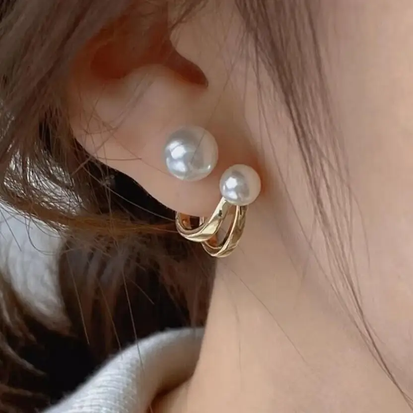 Pearl double hoop earrings worn close-up