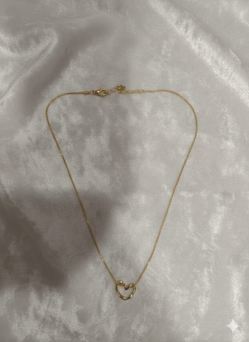 Gold-tone heart pendant necklace laid flat