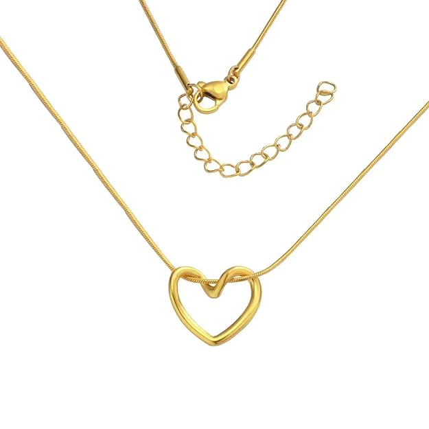 Gold-tone heart pendant necklace styled on a display surface