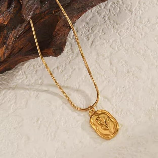 Gold-tone floral pendant necklace styled flat