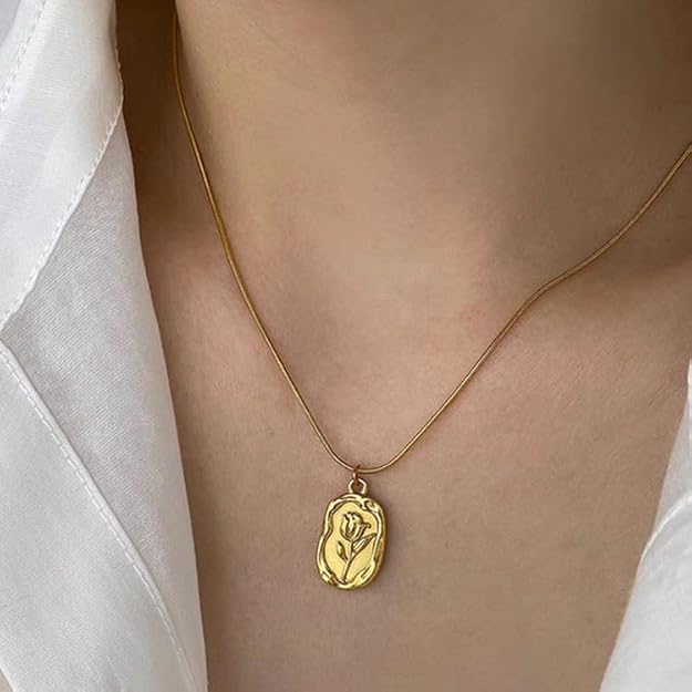 Gold-tone floral pendant necklace worn