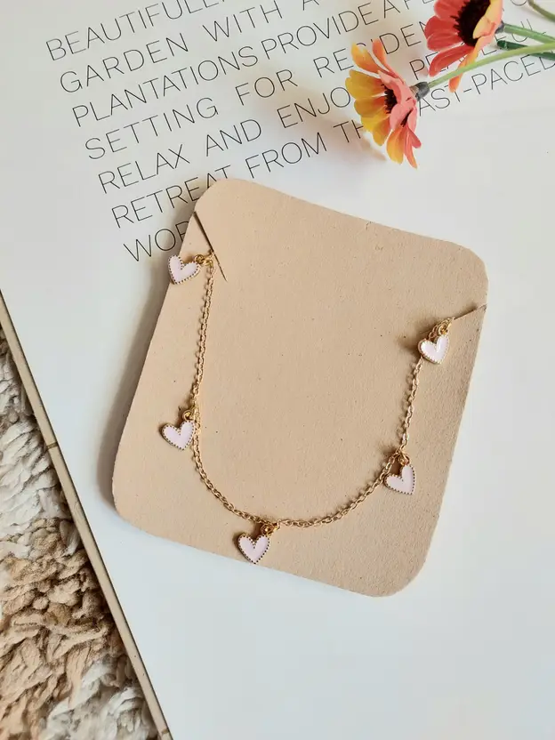 Gold-tone heart charm necklace with multiple heart pendants