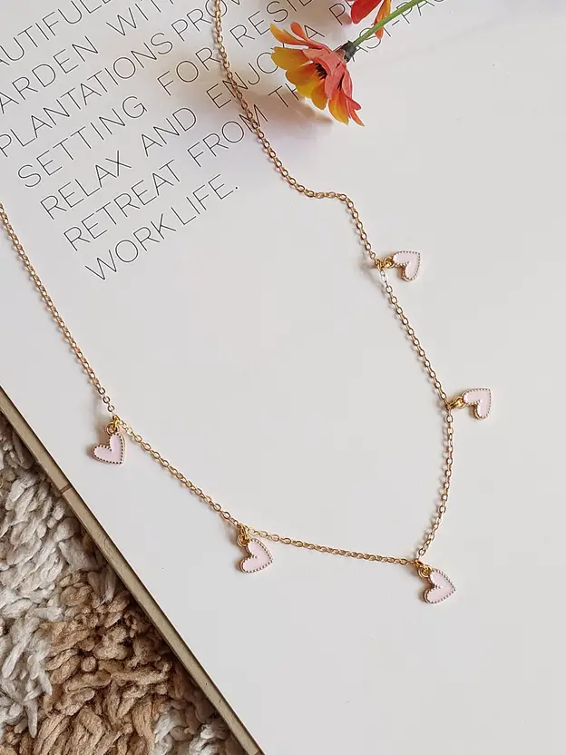 Gold-tone heart charm necklace clasp detail