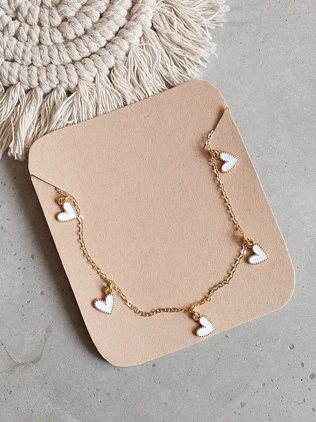 Gold-tone necklace with multiple white heart charms
