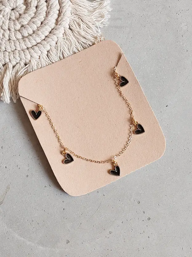 Gold-tone necklace with multiple black heart charms