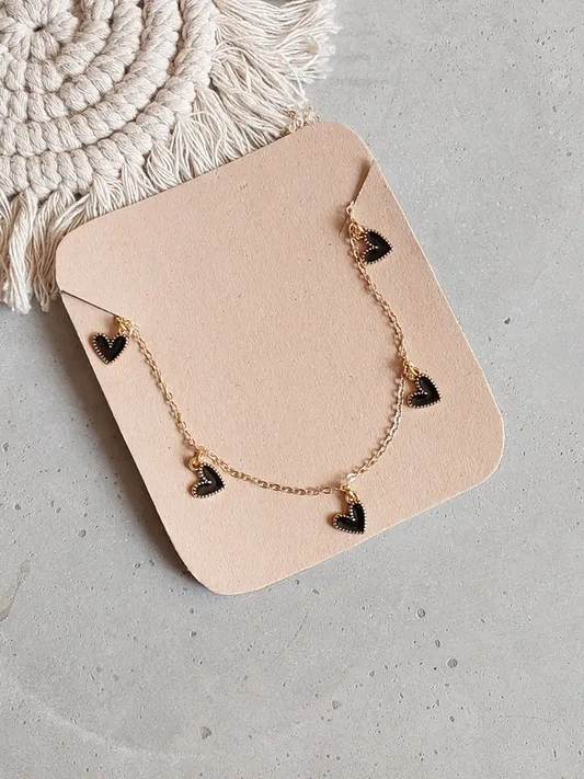 Gold-tone necklace with multiple black heart charms