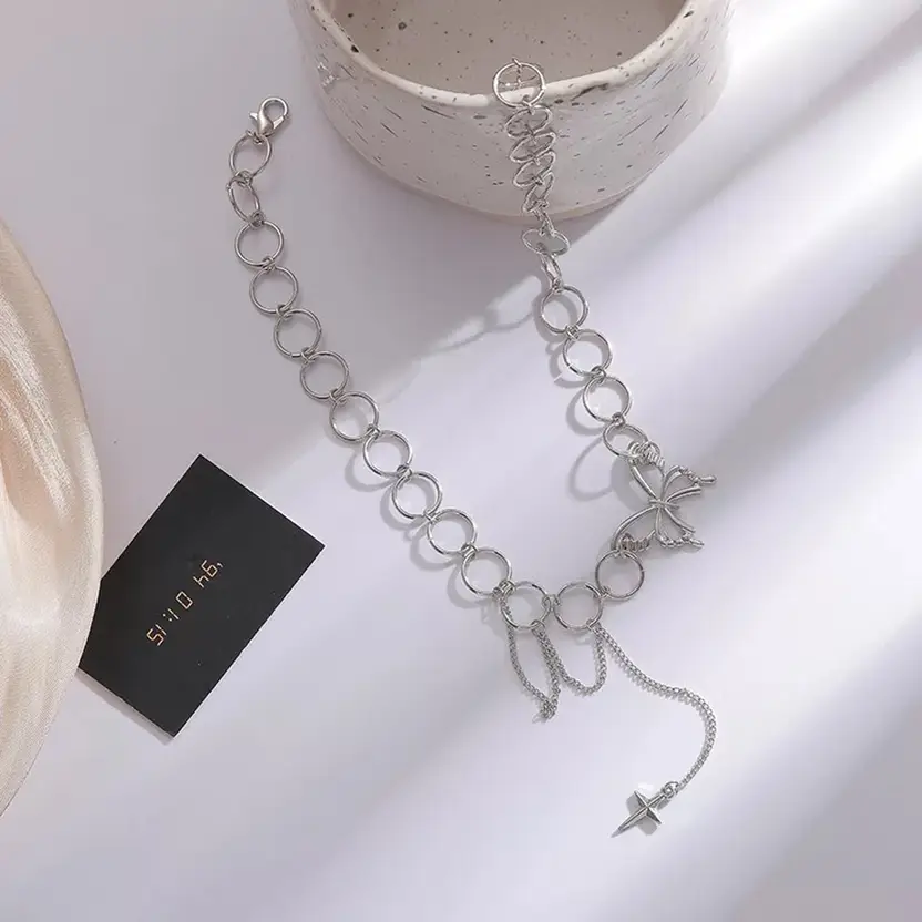 Silver-tone butterfly charm choker necklace worn on model
