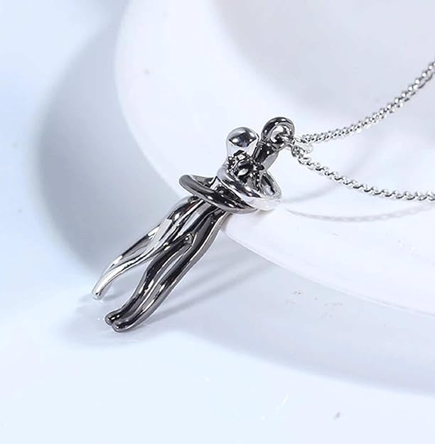 Close-up silver-tone couple pendant necklace