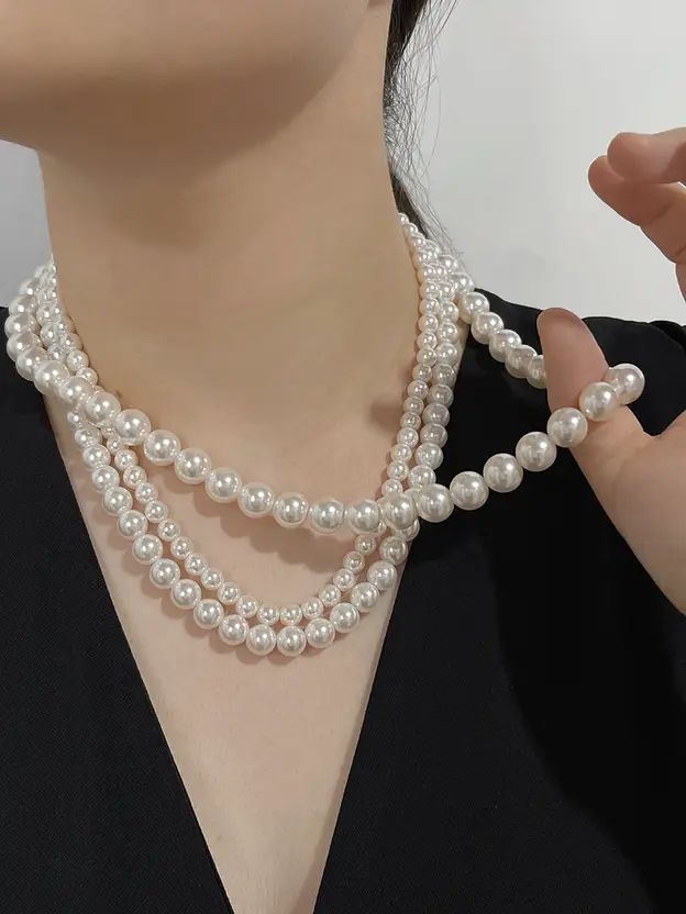 Three-layer white pearl necklace styled on a mannequin