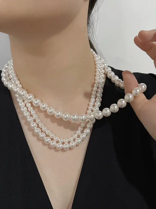 Three-layer white pearl necklace styled on a mannequin