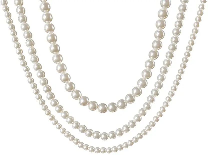 Three-layer white pearl necklace laid flat showing the full design