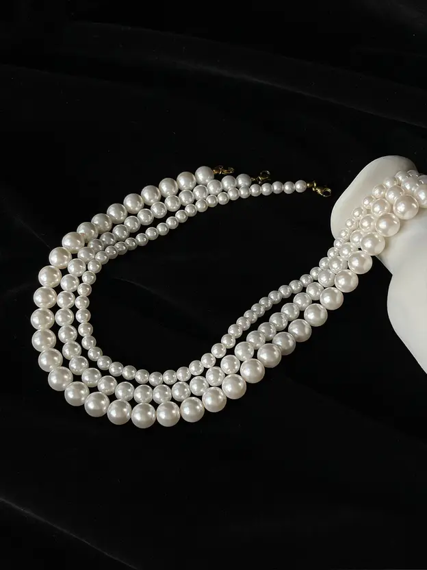 Three-layer white pearl necklace shown in full length