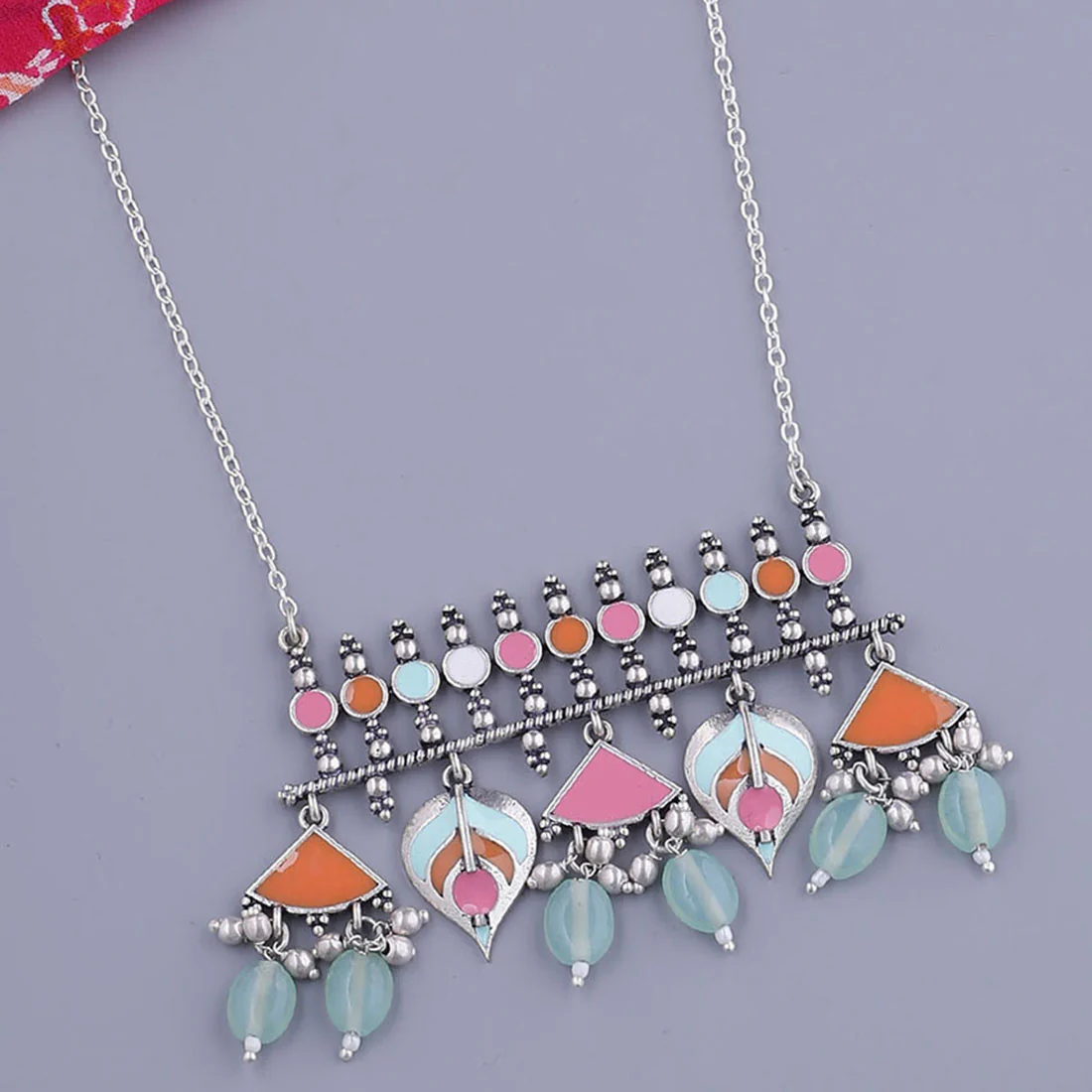 Multicolour silver-tone statement necklace shown in close-up on a black outfit
