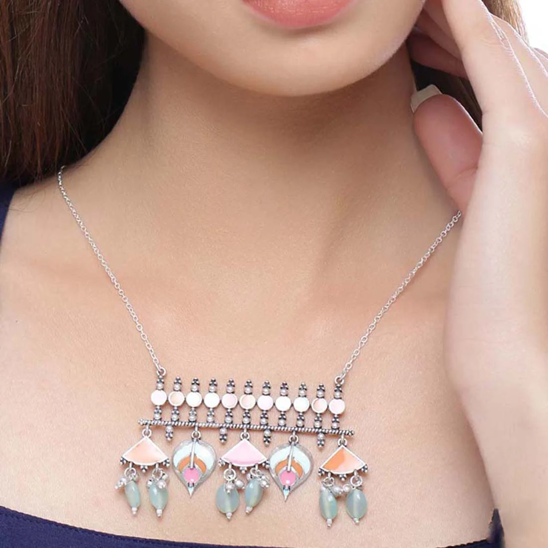 Multicolour silver-tone statement necklace worn as a layered pendant style
