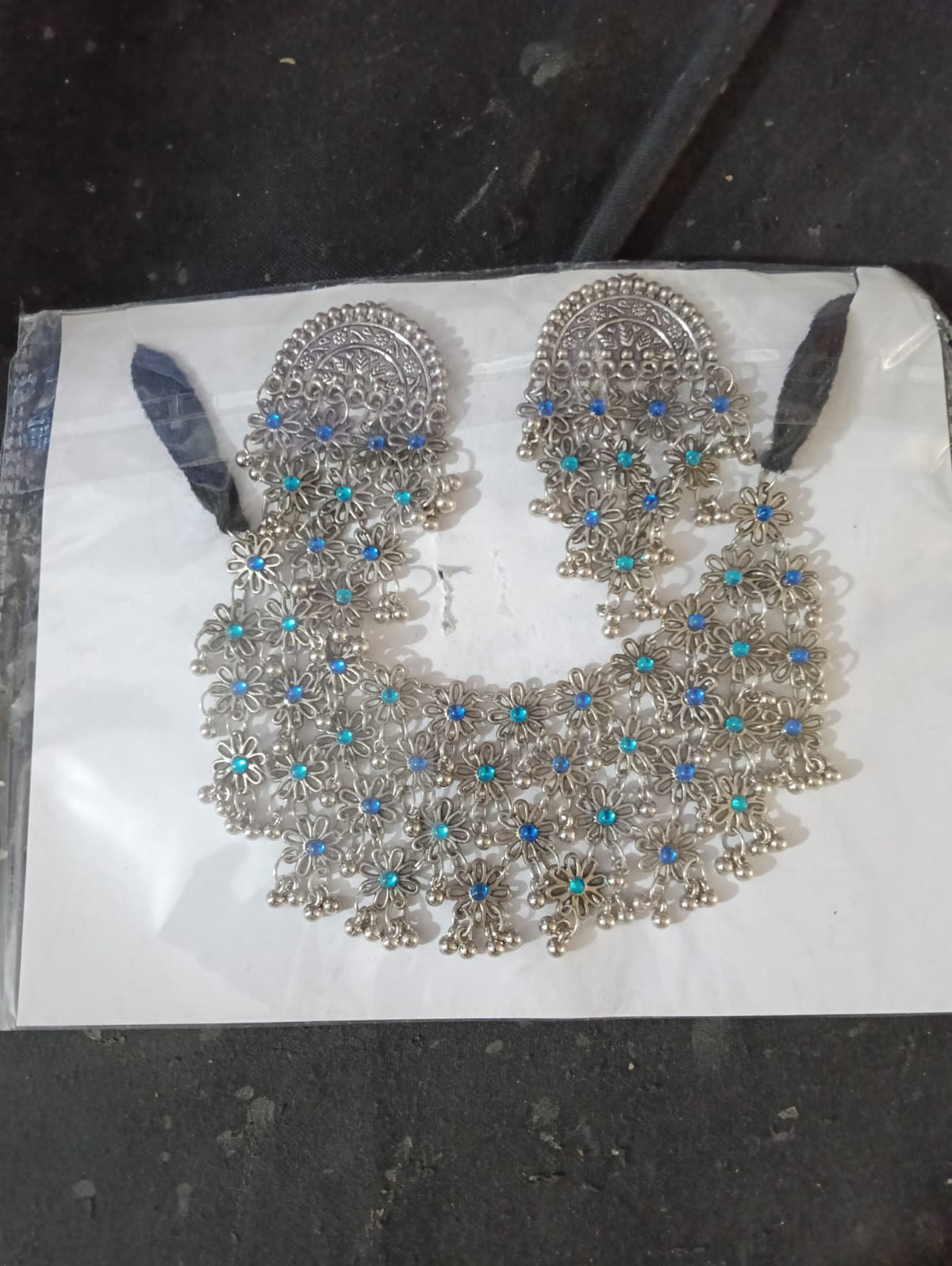 Blue and turquoise floral oxidised silver-tone necklace and earrings worn with a saree