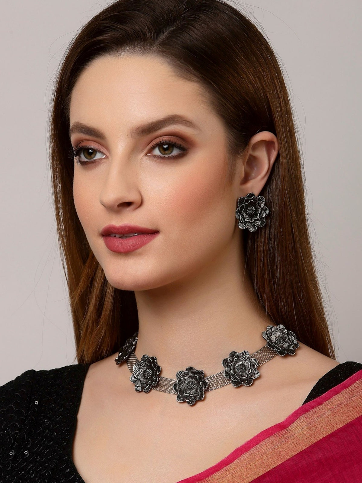 Floral oxidised silver-tone necklace and matching earrings on model