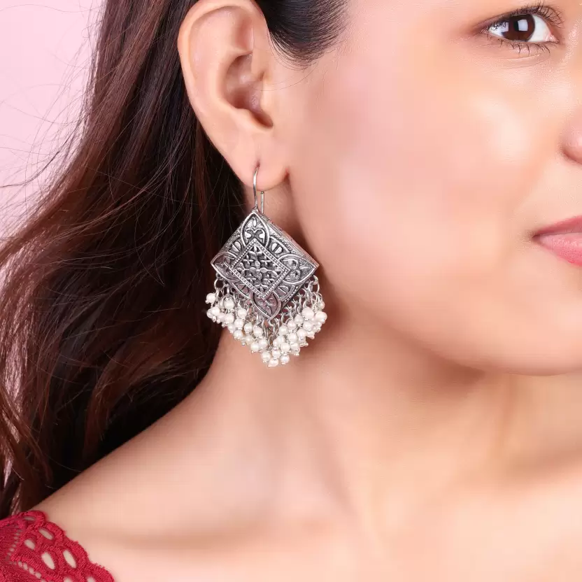Geometric oxidised silver-tone pearl tassel earrings worn on ear