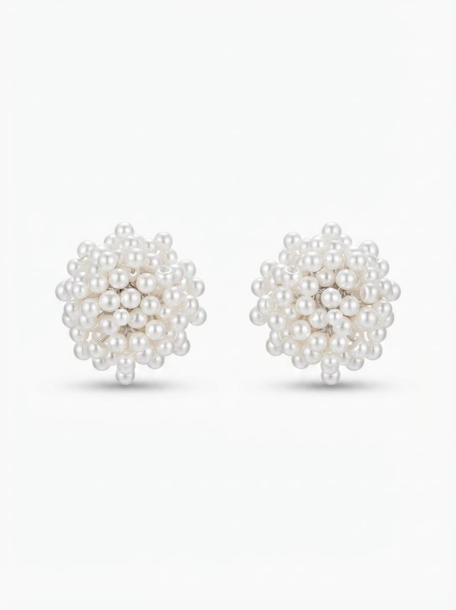 White pearl beaded stud earrings worn on ear