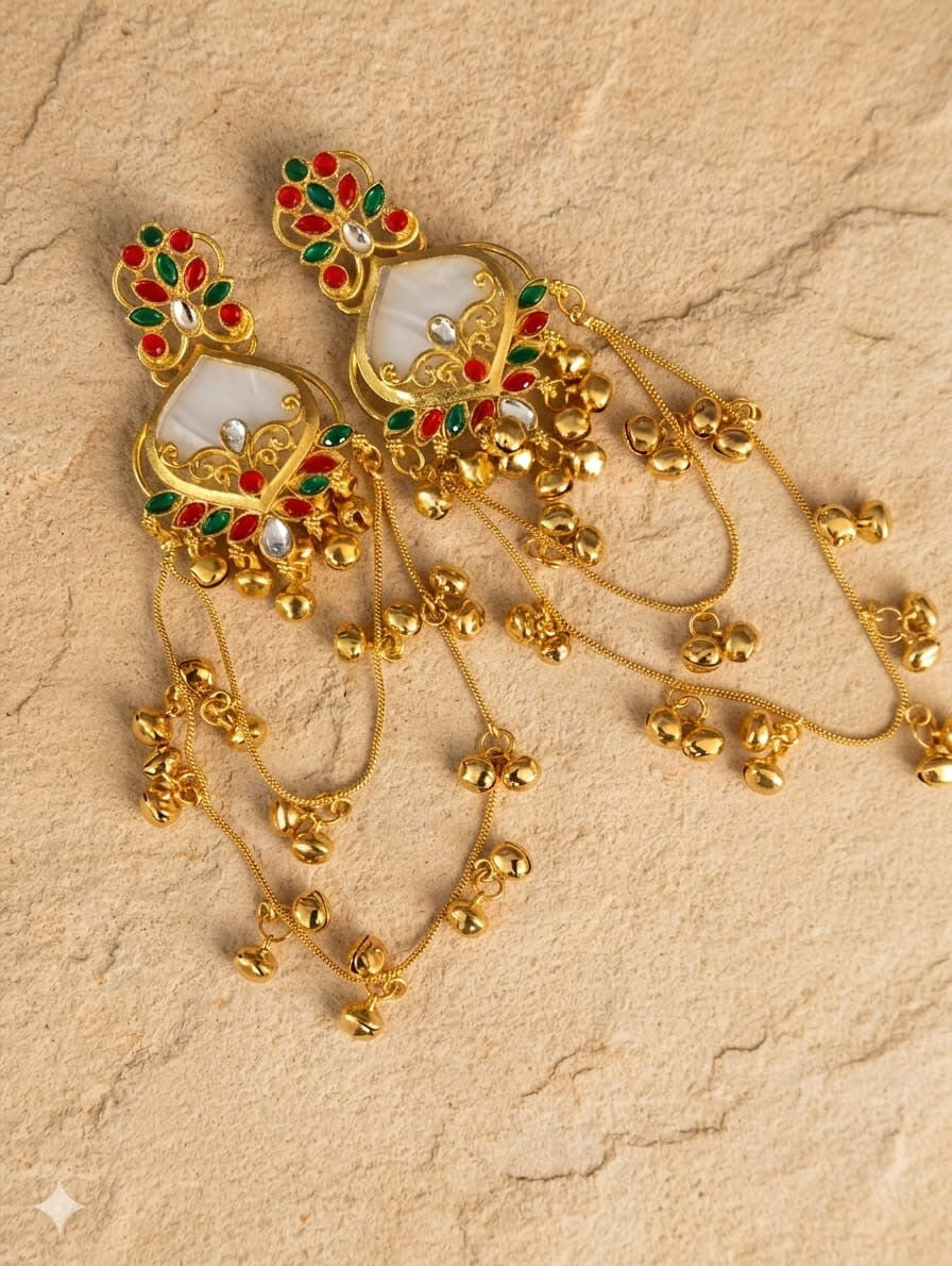 White red and green traditional long jhumka earrings styled on a model wearing a green saree