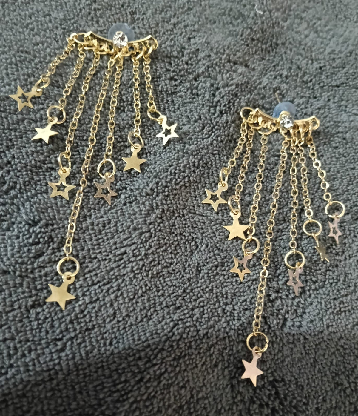 Gold-tone star chain earrings close-up