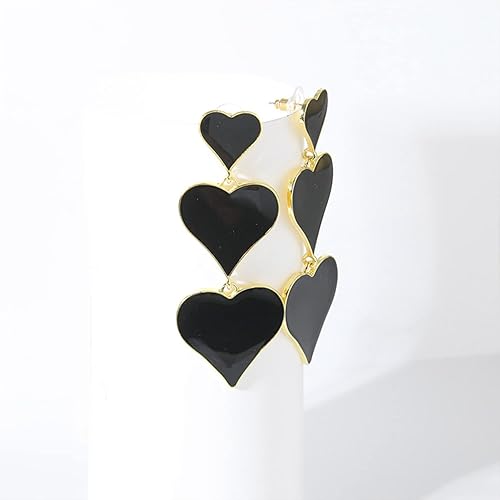 Black heart three-tier drop earrings on white background