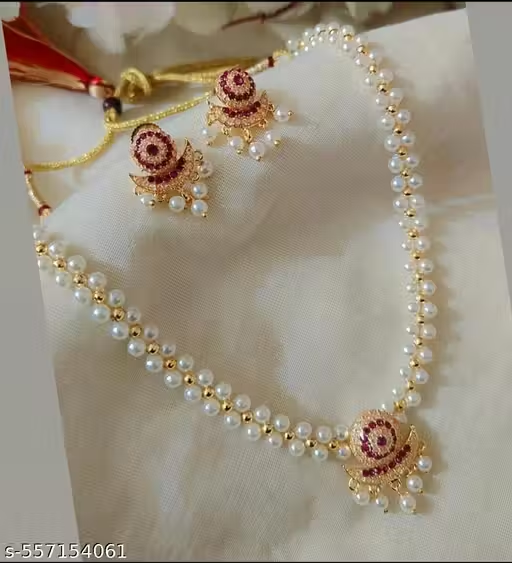 Pearl beaded red and gold necklace set worn with a red saree