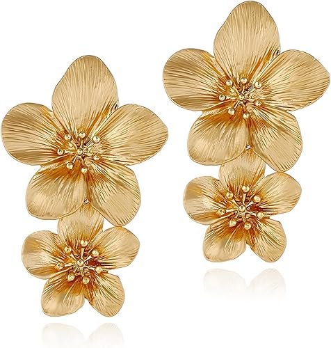 Gold-tone double flower dangle earrings on model